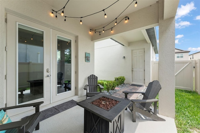 1787 White Feather Loop, Oakland, FL 34787 - view of patio / terrace featuring french doors and a fire pit