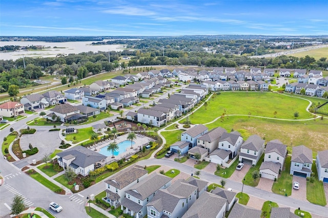 1787 White Feather Loop, Oakland, FL 34787 - aerial overview of property's location with nearby suburban area, a pool, and a large body of water