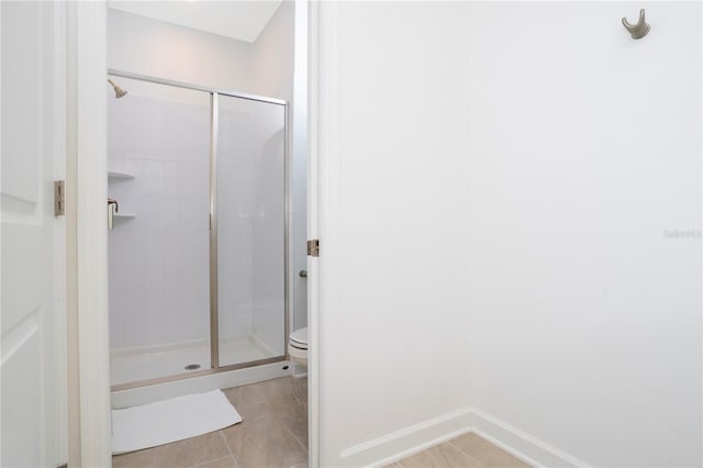 1070 Splash Shot Pl, Davenport, FL 33896 - full bathroom with a shower stall, toilet, tile patterned floors, and baseboards