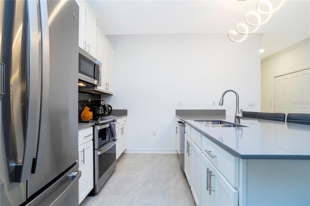 1070 Splash Shot Pl, Davenport, FL 33896 - kitchen featuring appliances with stainless steel finishes, a sink, white cabinets, a peninsula, and decorative backsplash