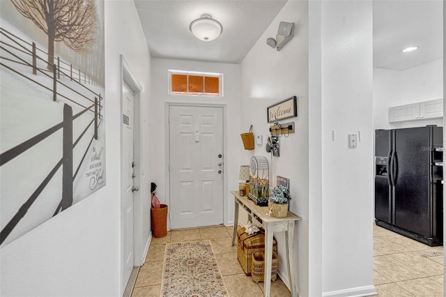 8152 Fan Palm Way, Kissimmee, FL 34747 - foyer with light tile patterned floors and baseboards