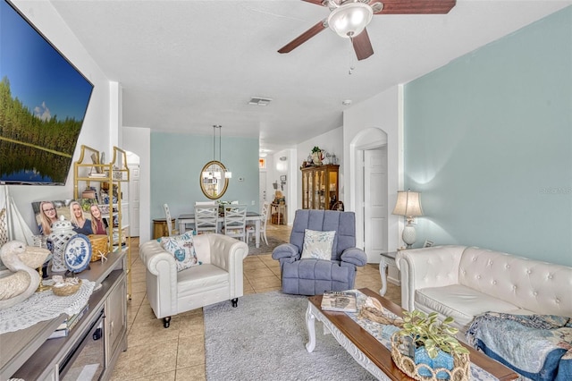 8152 Fan Palm Way, Kissimmee, FL 34747 - living room featuring light tile patterned floors, ceiling fan, arched walkways, and a chandelier