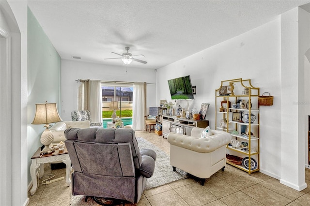 8152 Fan Palm Way, Kissimmee, FL 34747 - living room featuring ceiling fan, tile patterned floors, and a textured ceiling