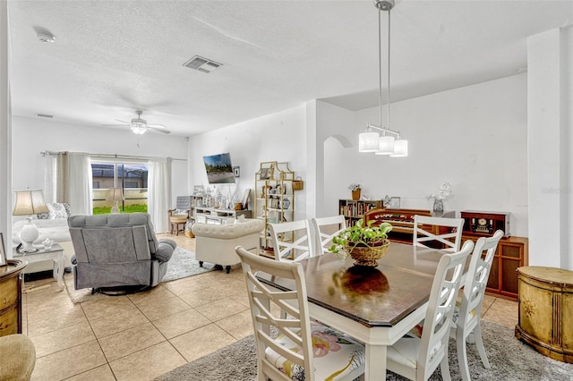 8152 Fan Palm Way, Kissimmee, FL 34747 - dining space with a ceiling fan, light tile patterned floors, and a textured ceiling