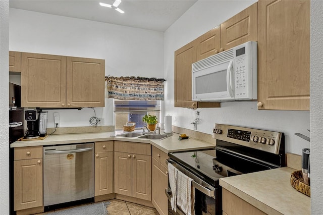 8152 Fan Palm Way, Kissimmee, FL 34747 - kitchen featuring stainless steel appliances, light countertops, light tile patterned flooring, and light brown cabinets