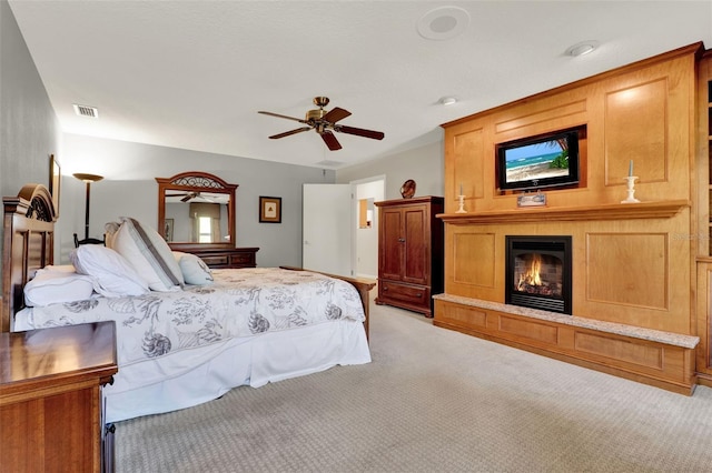 6836 Bittersweet Ln, Orlando, FL 32819 - bedroom with carpet floors, a glass covered fireplace, and a ceiling fan