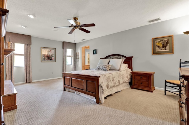 6836 Bittersweet Ln, Orlando, FL 32819 - bedroom featuring multiple windows, light colored carpet, a ceiling fan, and a textured ceiling
