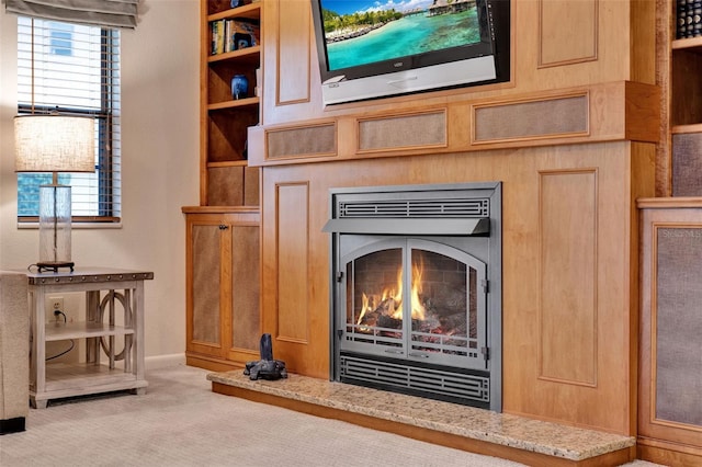 6836 Bittersweet Ln, Orlando, FL 32819 - detailed view of carpet flooring and a warm lit fireplace