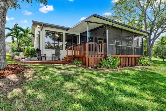 6836 Bittersweet Ln, Orlando, FL 32819 - rear view of house with a sunroom, a yard, a ceiling fan, and a wooden deck