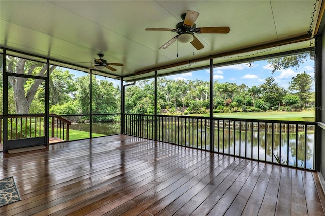 6836 Bittersweet Ln, Orlando, FL 32819 - unfurnished sunroom featuring ceiling fan, view of wooded area, and a water view