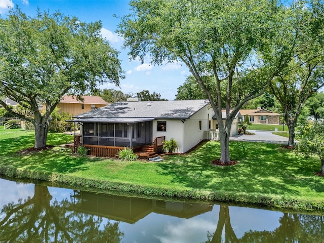 6836 Bittersweet Ln, Orlando, FL 32819 - rear view of property featuring a sunroom, a yard, and a water view