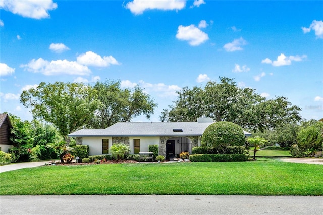 6836 Bittersweet Ln, Orlando, FL 32819 - ranch-style home with a front lawn and driveway