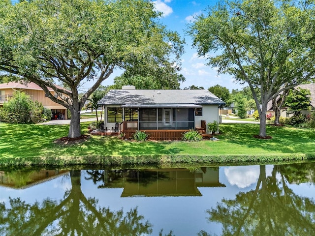 6836 Bittersweet Ln, Orlando, FL 32819 - rear view of house featuring a sunroom, a lawn, and a water view