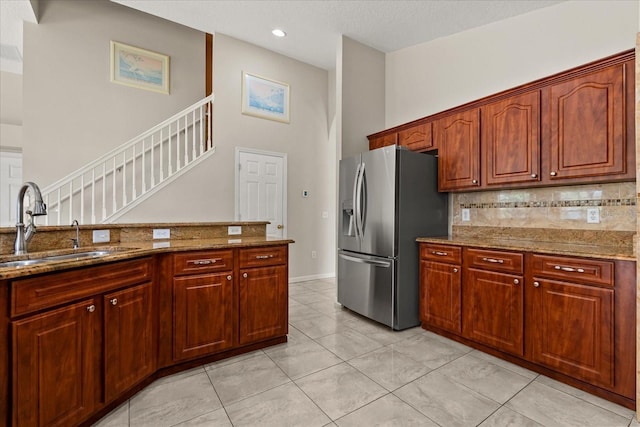 5200 Sunset Canyon Dr, Kissimmee, FL 34758 - kitchen featuring stainless steel refrigerator with ice dispenser, stone counters, tasteful backsplash, a high ceiling, and recessed lighting