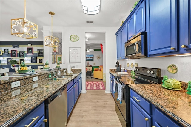 5012 Shoreway Loop Unit 10107, Orlando, FL 32819 - kitchen with appliances with stainless steel finishes, blue cabinetry, light wood finished floors, and dark stone counters