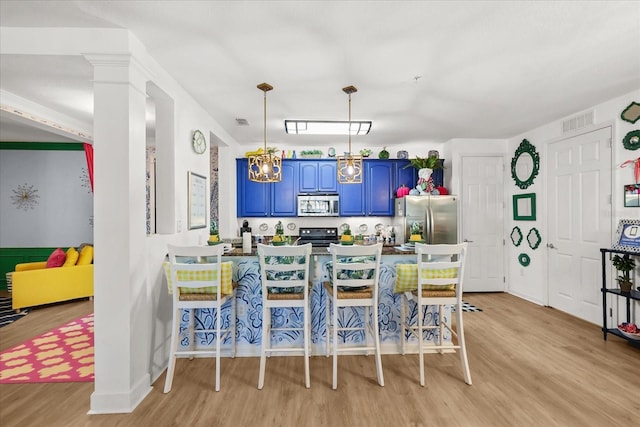 5012 Shoreway Loop Unit 10107, Orlando, FL 32819 - dining area with light wood-style floors and a chandelier