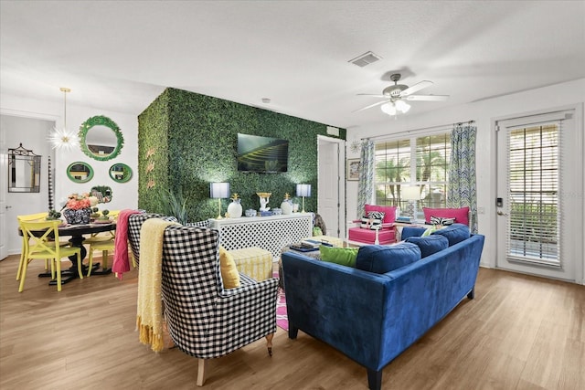 5012 Shoreway Loop Unit 10107, Orlando, FL 32819 - living area with wood finished floors, ceiling fan, and an accent wall