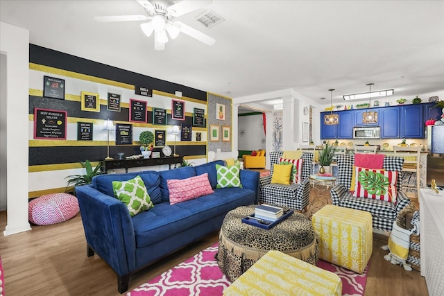 5012 Shoreway Loop Unit 10107, Orlando, FL 32819 - living area with decorative columns, wood finished floors, and ceiling fan