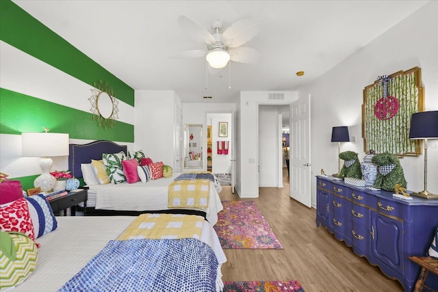 5012 Shoreway Loop Unit 10107, Orlando, FL 32819 - bedroom featuring wood finished floors and a ceiling fan