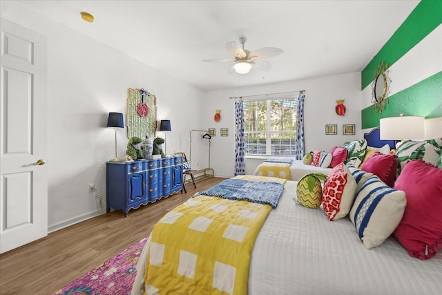 5012 Shoreway Loop Unit 10107, Orlando, FL 32819 - bedroom featuring wood finished floors, baseboards, and ceiling fan