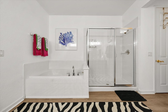 5012 Shoreway Loop Unit 10107, Orlando, FL 32819 - bathroom with a garden tub, a shower stall, and wood finished floors