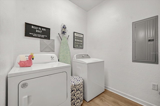 5012 Shoreway Loop Unit 10107, Orlando, FL 32819 - laundry room featuring electric panel, independent washer and dryer, light wood-style floors, and baseboards