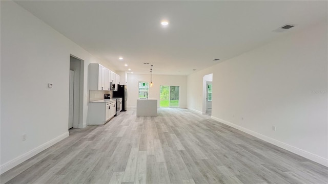 2486 W Magenta Dr, Citrus Springs, FL 34434 - unfurnished living room with light wood-type flooring and recessed lighting