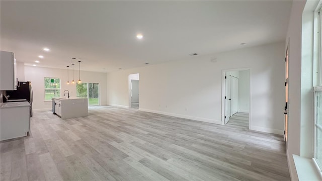 2486 W Magenta Dr, Citrus Springs, FL 34434 - unfurnished living room with light wood-type flooring and recessed lighting