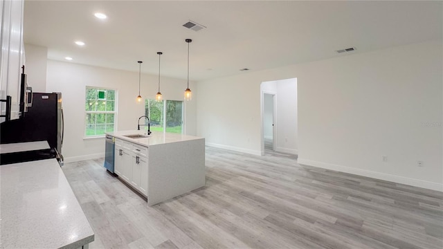 2486 W Magenta Dr, Citrus Springs, FL 34434 - kitchen featuring dishwasher, white cabinets, decorative light fixtures, light wood-style floors, and recessed lighting