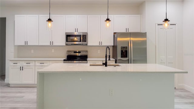 2486 W Magenta Dr, Citrus Springs, FL 34434 - kitchen featuring stainless steel appliances, light wood-style floors, and white cabinetry