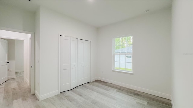 2486 W Magenta Dr, Citrus Springs, FL 34434 - unfurnished bedroom with light wood finished floors and a closet