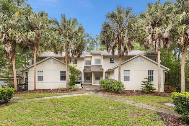 2825 NW 104th Ct Unit B, Gainesville, FL 32606 - view of front of home with a front lawn, central AC unit, and stucco siding