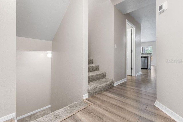 2825 NW 104th Ct Unit B, Gainesville, FL 32606 - staircase with wood finished floors and baseboards