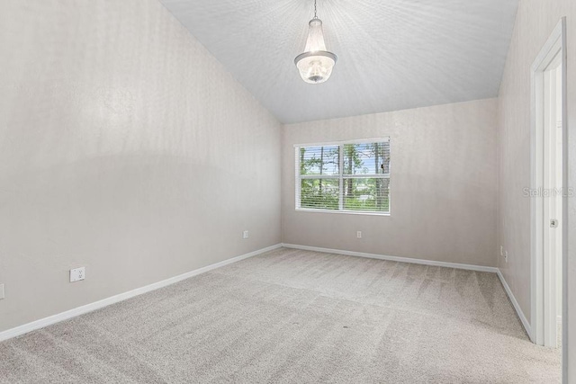 2825 NW 104th Ct Unit B, Gainesville, FL 32606 - unfurnished room with carpet flooring, lofted ceiling, a chandelier, and baseboards