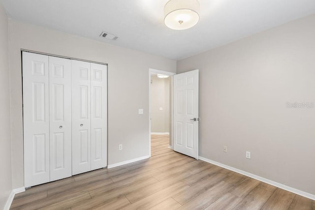 2825 NW 104th Ct Unit B, Gainesville, FL 32606 - unfurnished bedroom with wood finished floors, baseboards, and a closet
