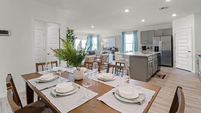 3585 Roden Rd, Haines City, FL 33844 - dining area with recessed lighting, light wood-style flooring, and baseboards