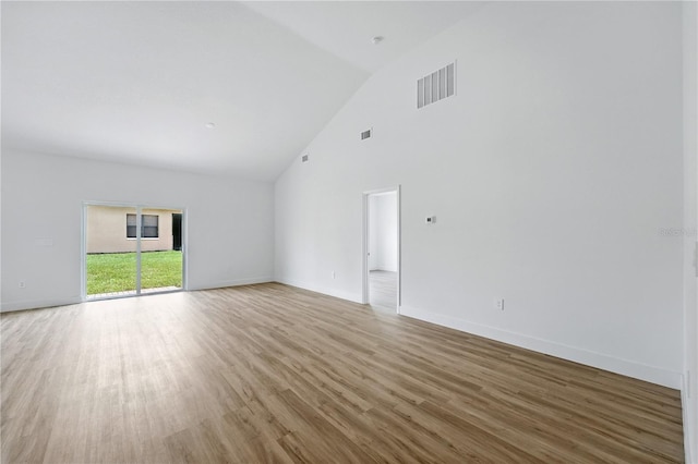 436 Caraway Dr, Kissimmee, FL 34759 - unfurnished room with wood finished floors and high vaulted ceiling