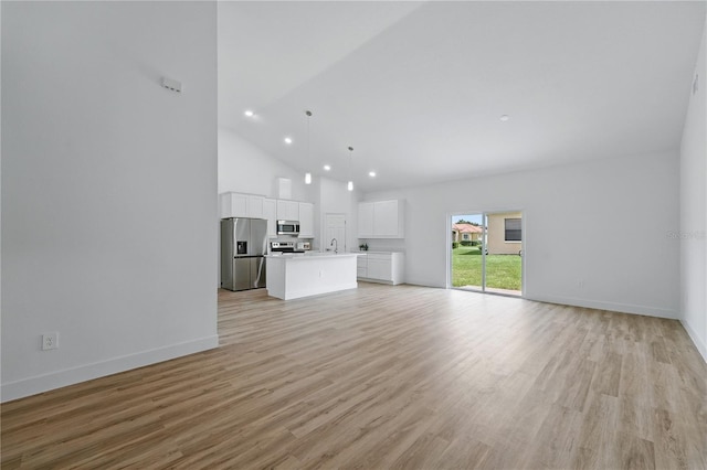 436 Caraway Dr, Kissimmee, FL 34759 - unfurnished living room featuring recessed lighting, light wood-style flooring, and high vaulted ceiling