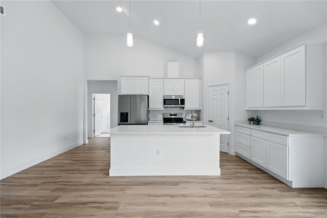 436 Caraway Dr, Kissimmee, FL 34759 - kitchen with appliances with stainless steel finishes, high vaulted ceiling, light countertops, white cabinetry, and pendant lighting