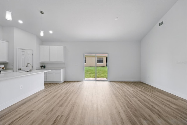 436 Caraway Dr, Kissimmee, FL 34759 - unfurnished living room with light wood-style flooring, vaulted ceiling, and recessed lighting