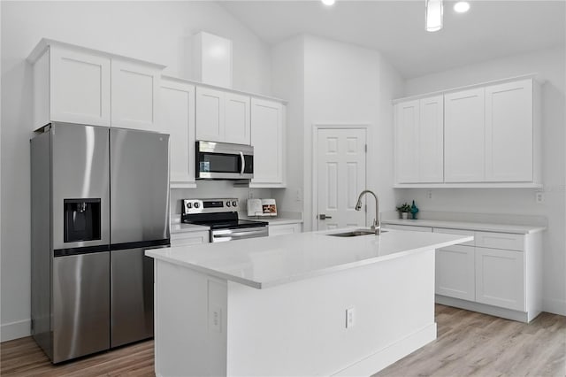436 Caraway Dr, Kissimmee, FL 34759 - kitchen featuring appliances with stainless steel finishes, white cabinets, a center island with sink, light wood-style flooring, and recessed lighting