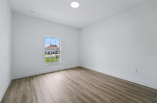 436 Caraway Dr, Kissimmee, FL 34759 - empty room with wood finished floors and baseboards