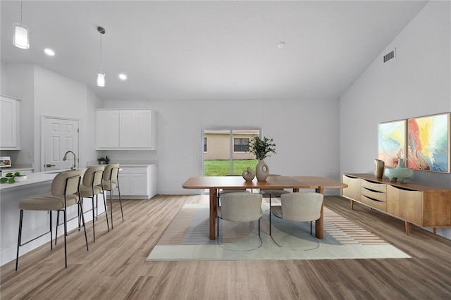 436 Caraway Dr, Kissimmee, FL 34759 - dining space with lofted ceiling, light wood-type flooring, and recessed lighting