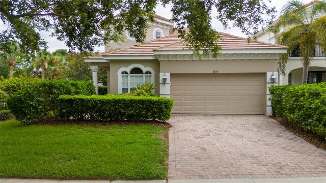 8108 Via Bella Notte, Orlando, FL 32836 - view of front of house with stucco siding, driveway, an attached garage, a tile roof, and a front yard
