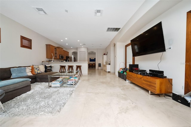8108 Via Bella Notte, Orlando, FL 32836 - living area featuring arched walkways, recessed lighting, and light tile patterned floors