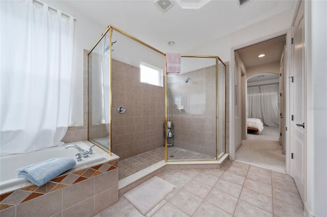 8108 Via Bella Notte, Orlando, FL 32836 - ensuite bathroom with tile patterned flooring, a stall shower, and a bath