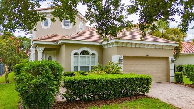 8108 Via Bella Notte, Orlando, FL 32836 - view of front of house featuring a tiled roof, stucco siding, a garage, and driveway