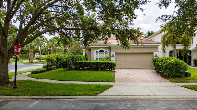8108 Via Bella Notte, Orlando, FL 32836 - obstructed view of property featuring decorative driveway, an attached garage, stucco siding, and a front lawn