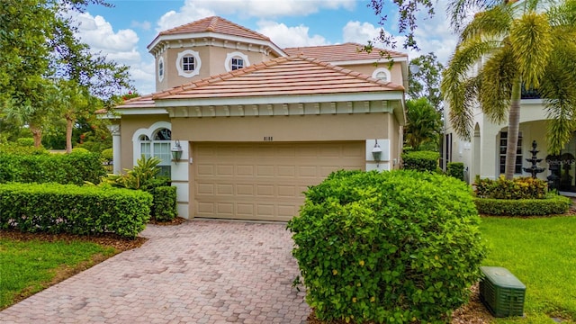 8108 Via Bella Notte, Orlando, FL 32836 - mediterranean / spanish home with stucco siding, a tile roof, decorative driveway, and an attached garage