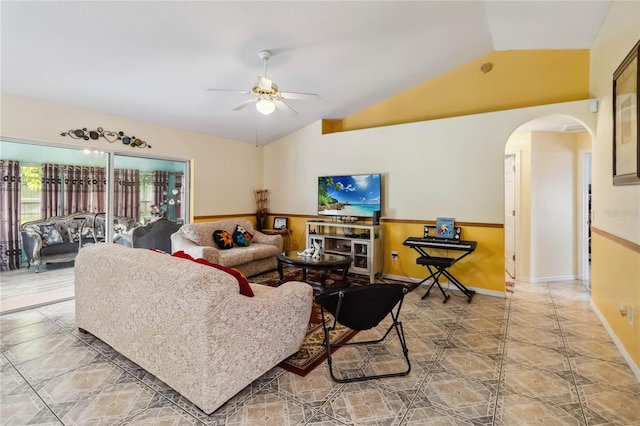 176 Hidden View Dr, Groveland, FL 34736 - living area featuring arched walkways, vaulted ceiling, a ceiling fan, a wainscoted wall, and light tile patterned floors